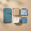 The Summer Survival Kit — complete 5-piece dog cooling set flat-lay: ice-silk mat, elevated cot, water fountain, cooling vest, and freezable lick mats