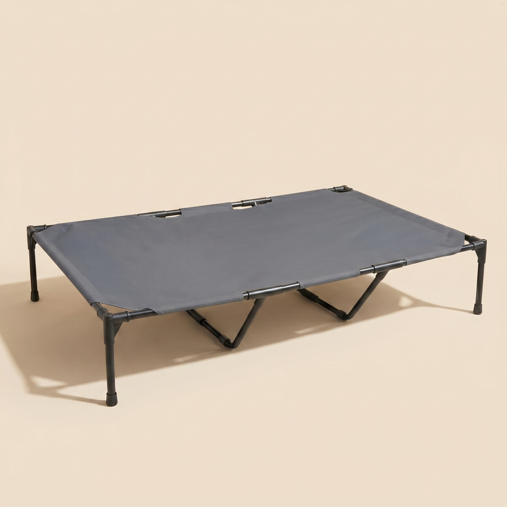 Mesa Cot elevated cooling dog bed on a clean sand studio background