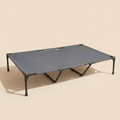 Mesa Cot elevated cooling dog bed on a clean sand studio background