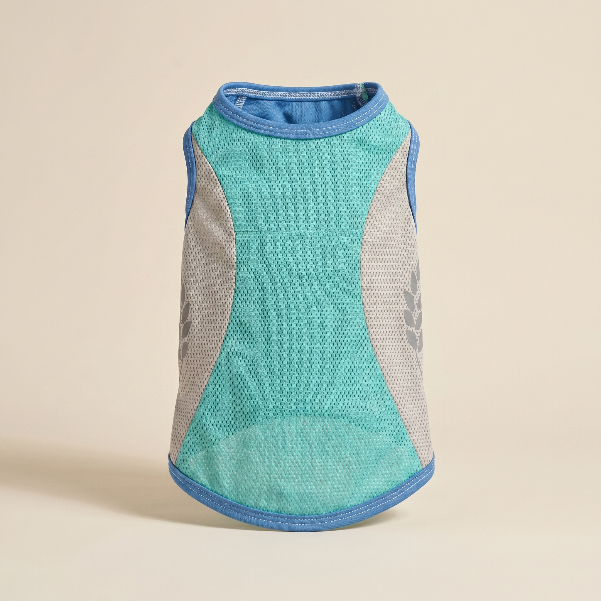Río Vest evaporative dog cooling vest in teal on a clean sand studio background
